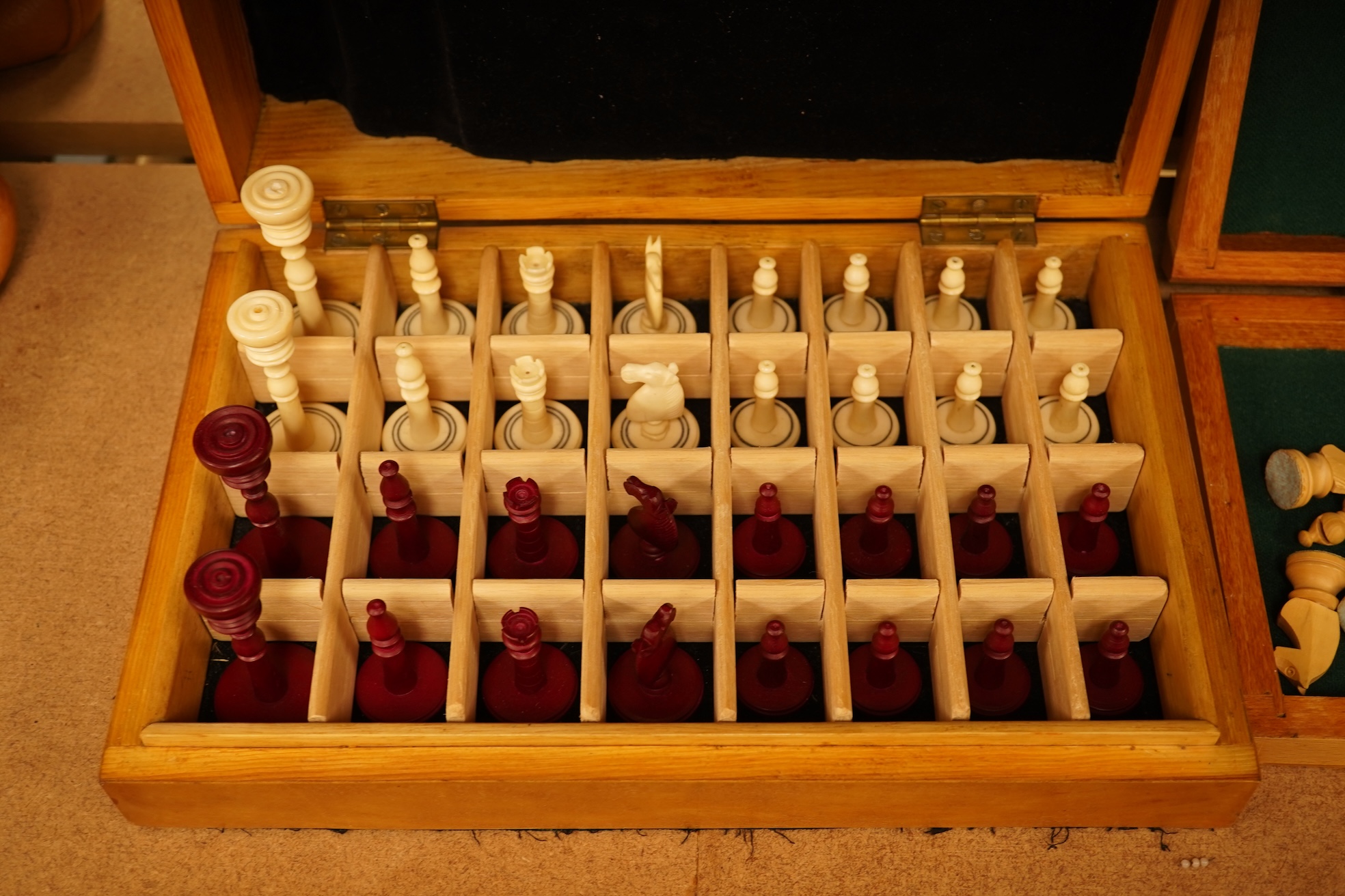 Two boxed chess sets, a cricket ball and a bird scaring rattle, largest chess set 32cm wide x 9cm high x 20cm deep.